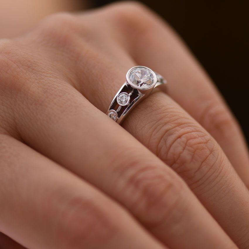 Bezel Set Diamond Engagement Ring with bezel set Diamond accents hand view
