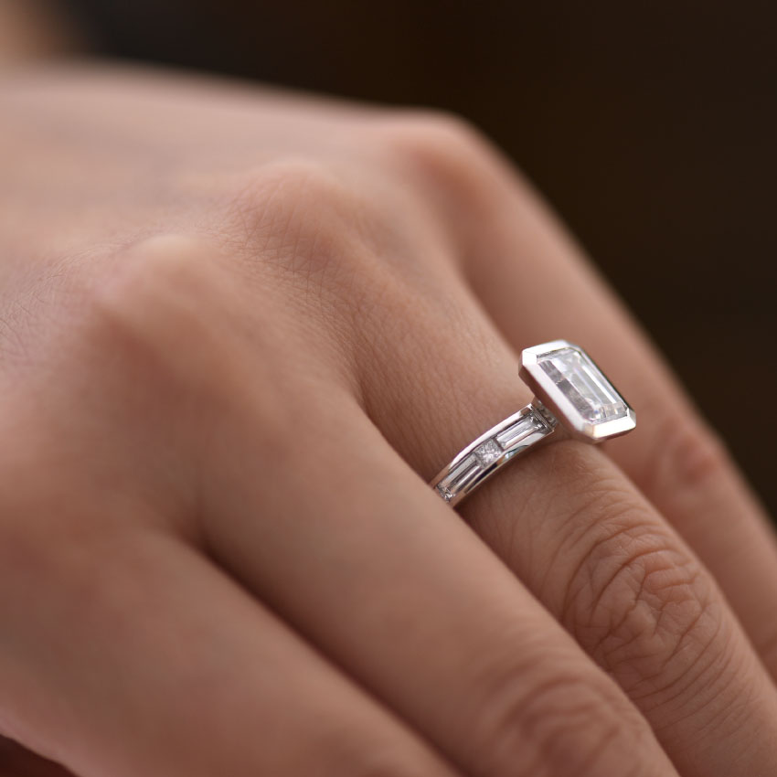 Bezel Set Emerald Cut Diamond Engagement Ring Hand View