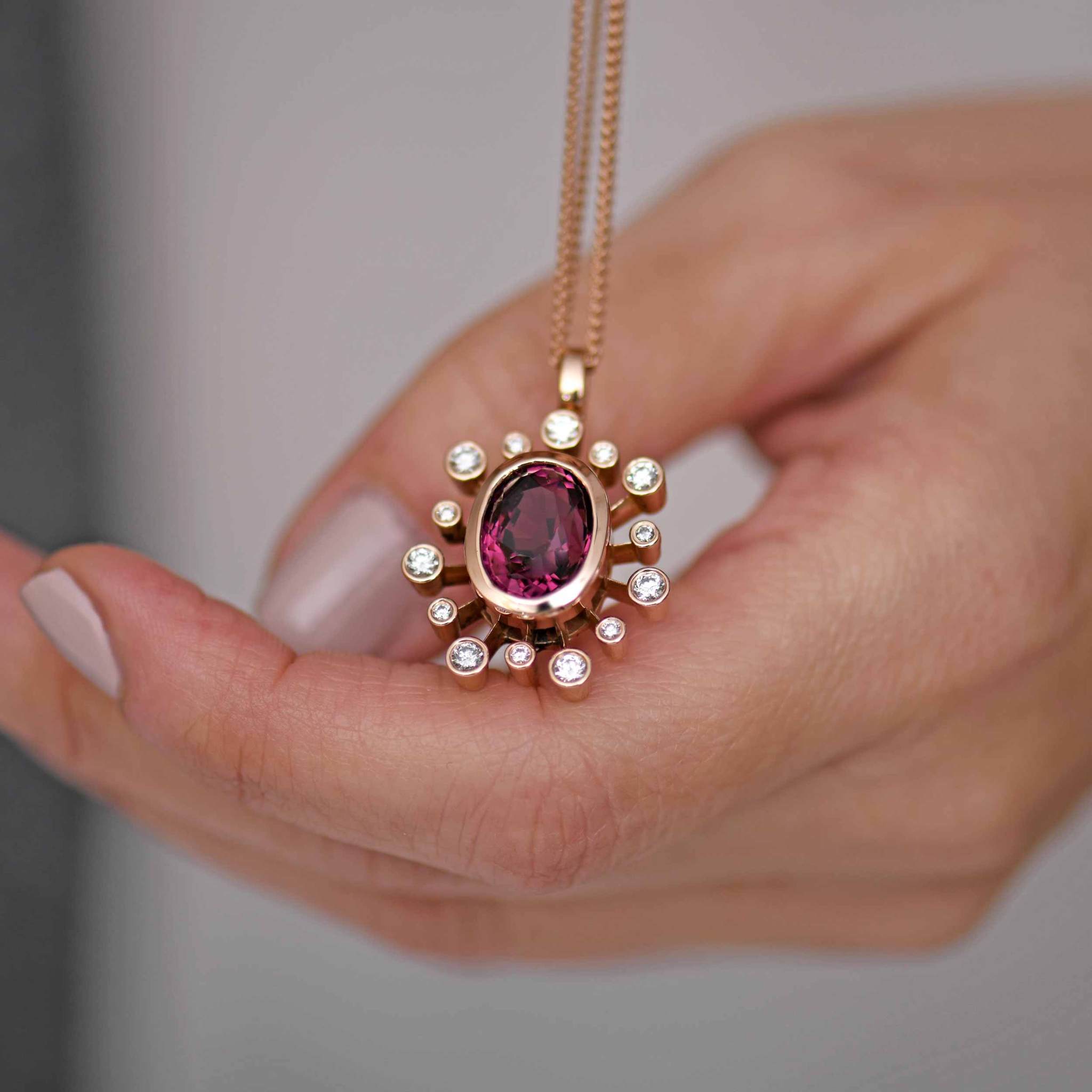 Fire Flower Rhodolite Garnet and Diamond Fireworks Necklace on hand