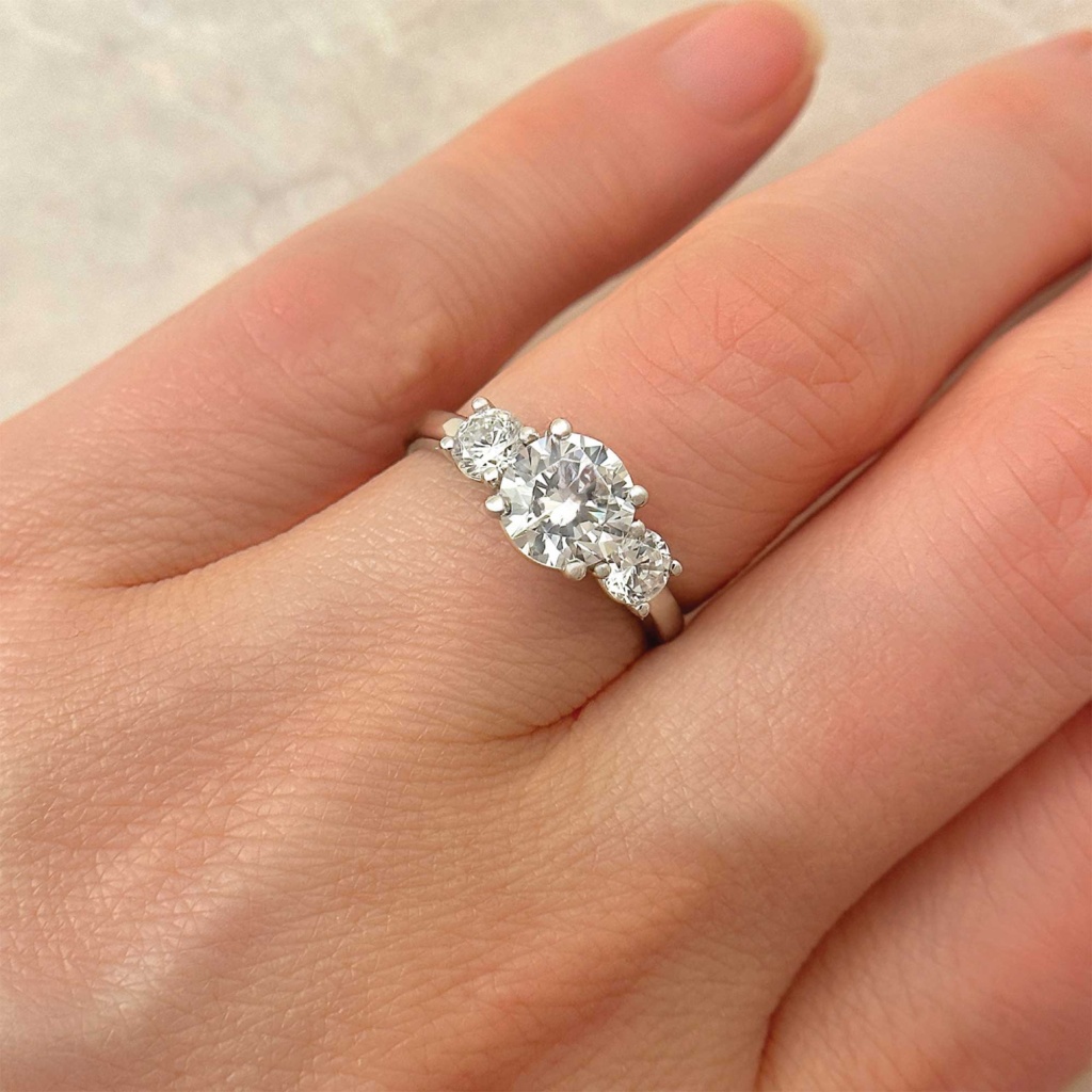 Three stone round brilliant diamond classic engagement ring fine jewelry on finger