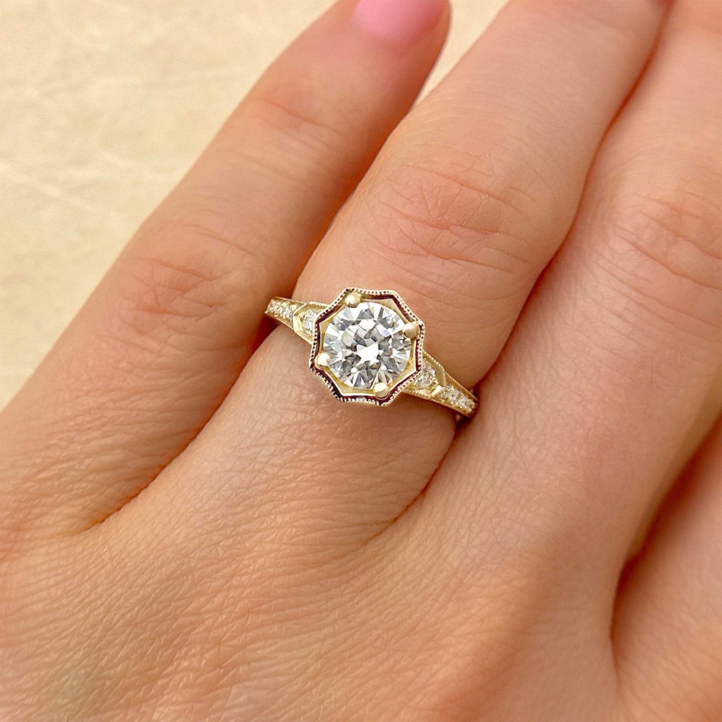hand engraved round Brilliant diamond vintage engagement ring with halo and stepped band yellow gold on finger