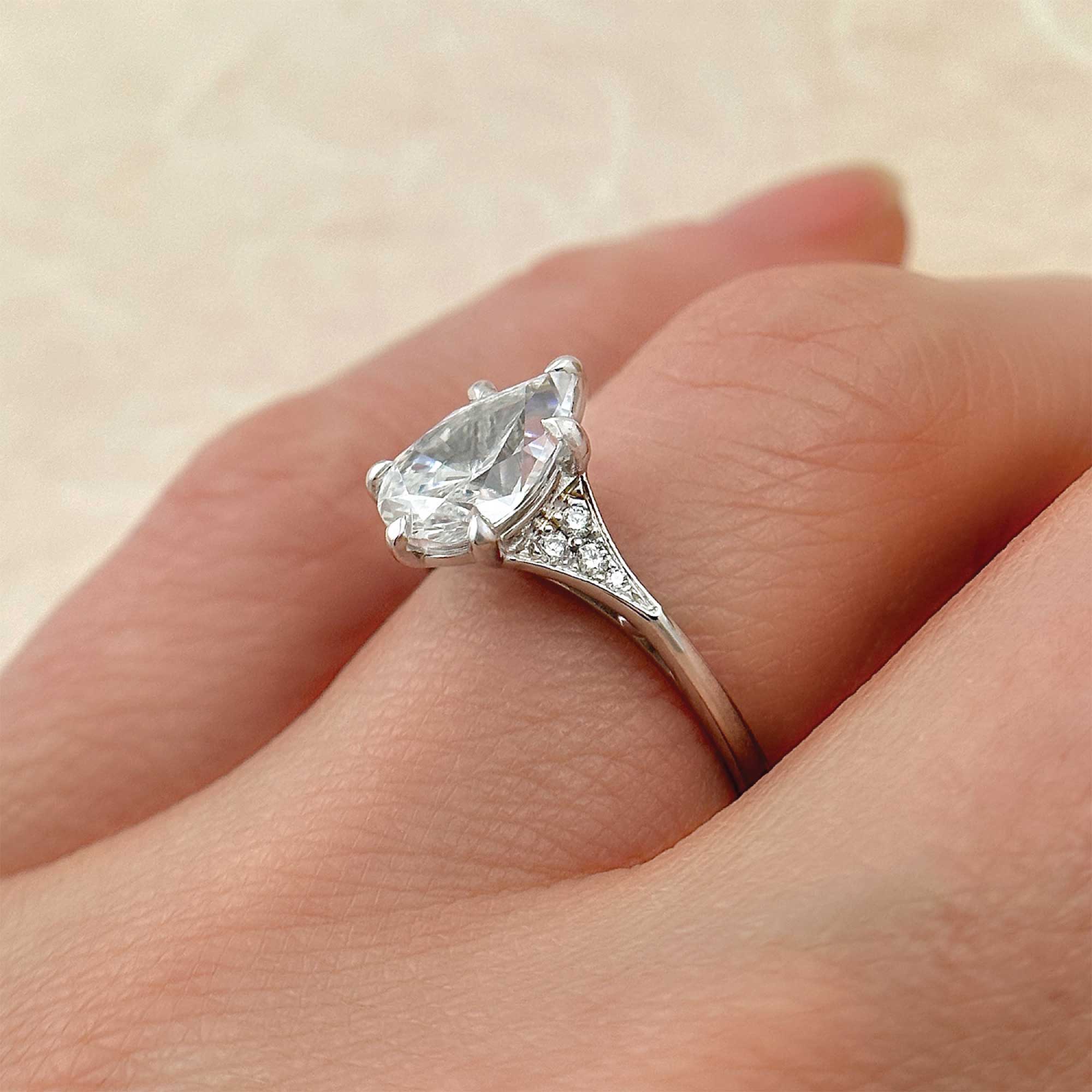 pear-shape-classic-diamond-engagement-ring-with-pave-accents-in-a-streamlined-band