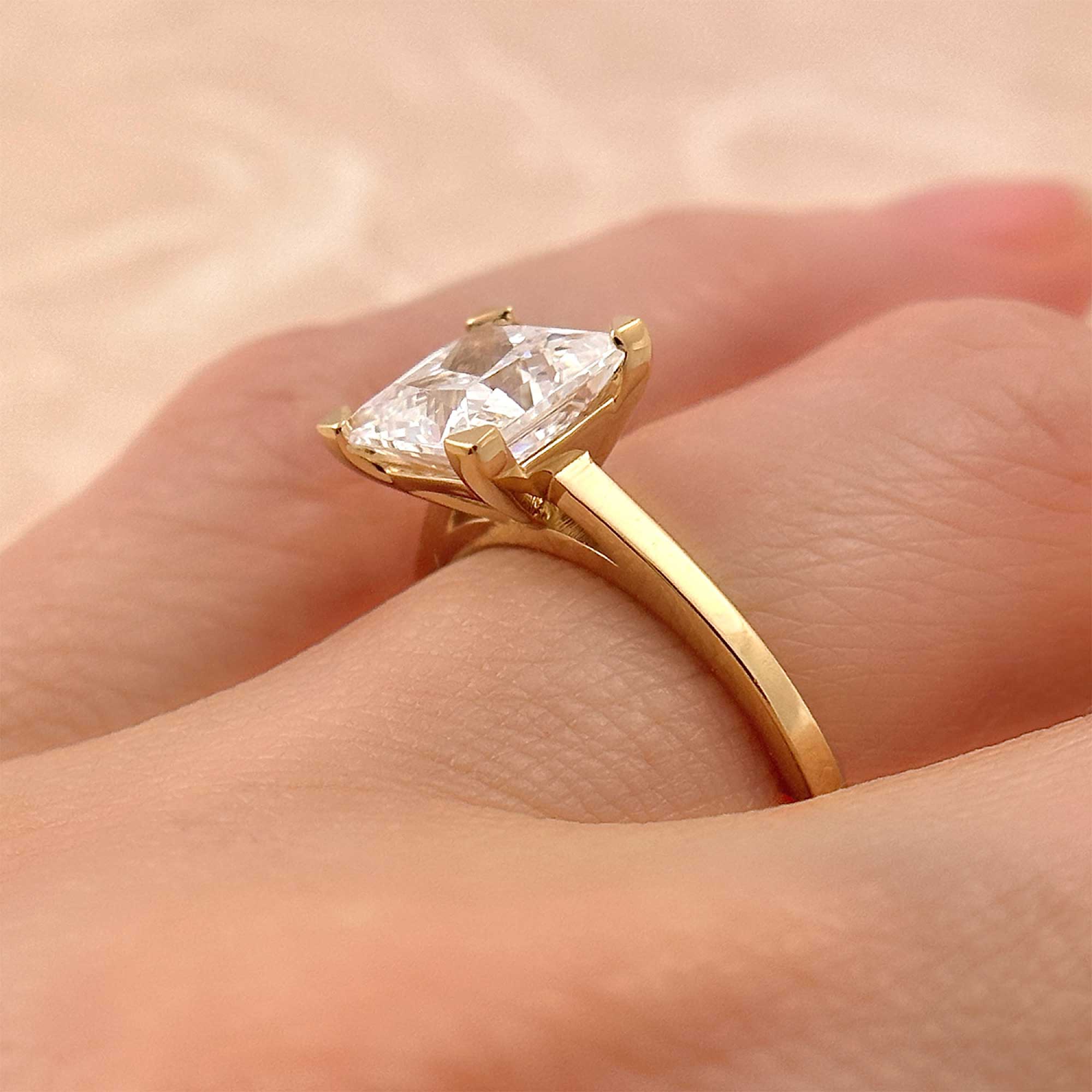 princess cut diamond minimalist engagement ring on finger