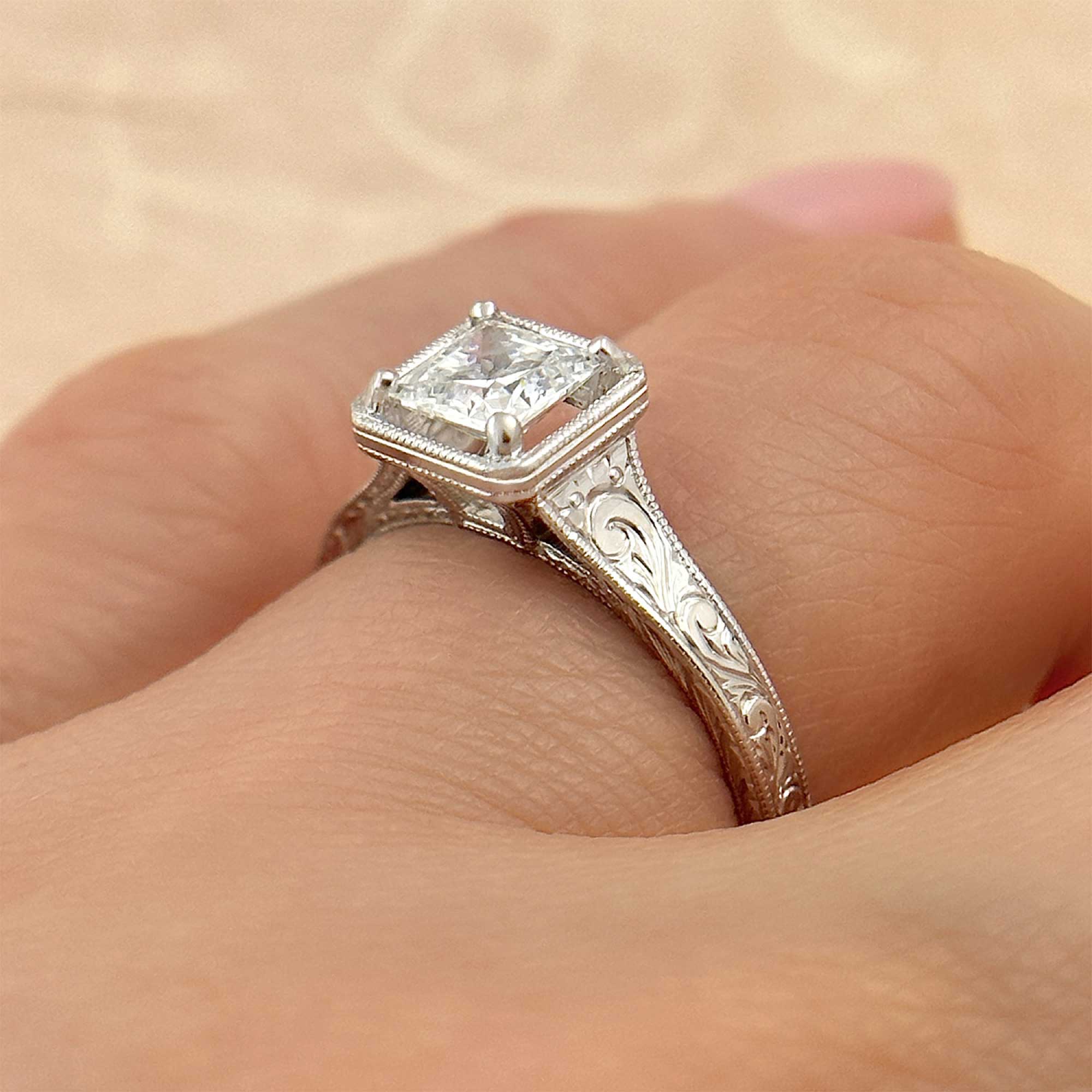 princess cut vintage style diamond engagement ring on finger alt view