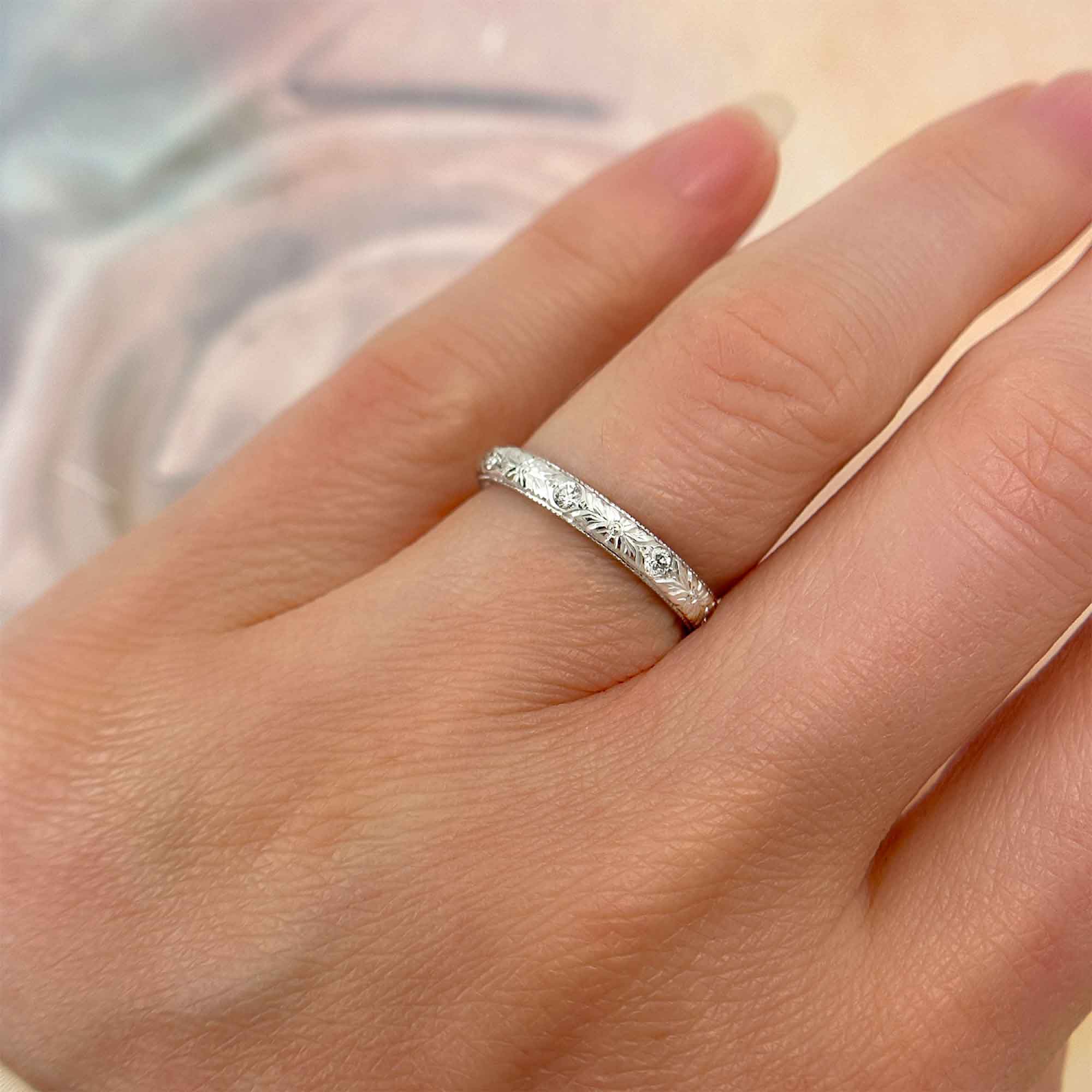 Alternating Hand-engraved Floral Pattern, White Gold Band, on Ring Finger