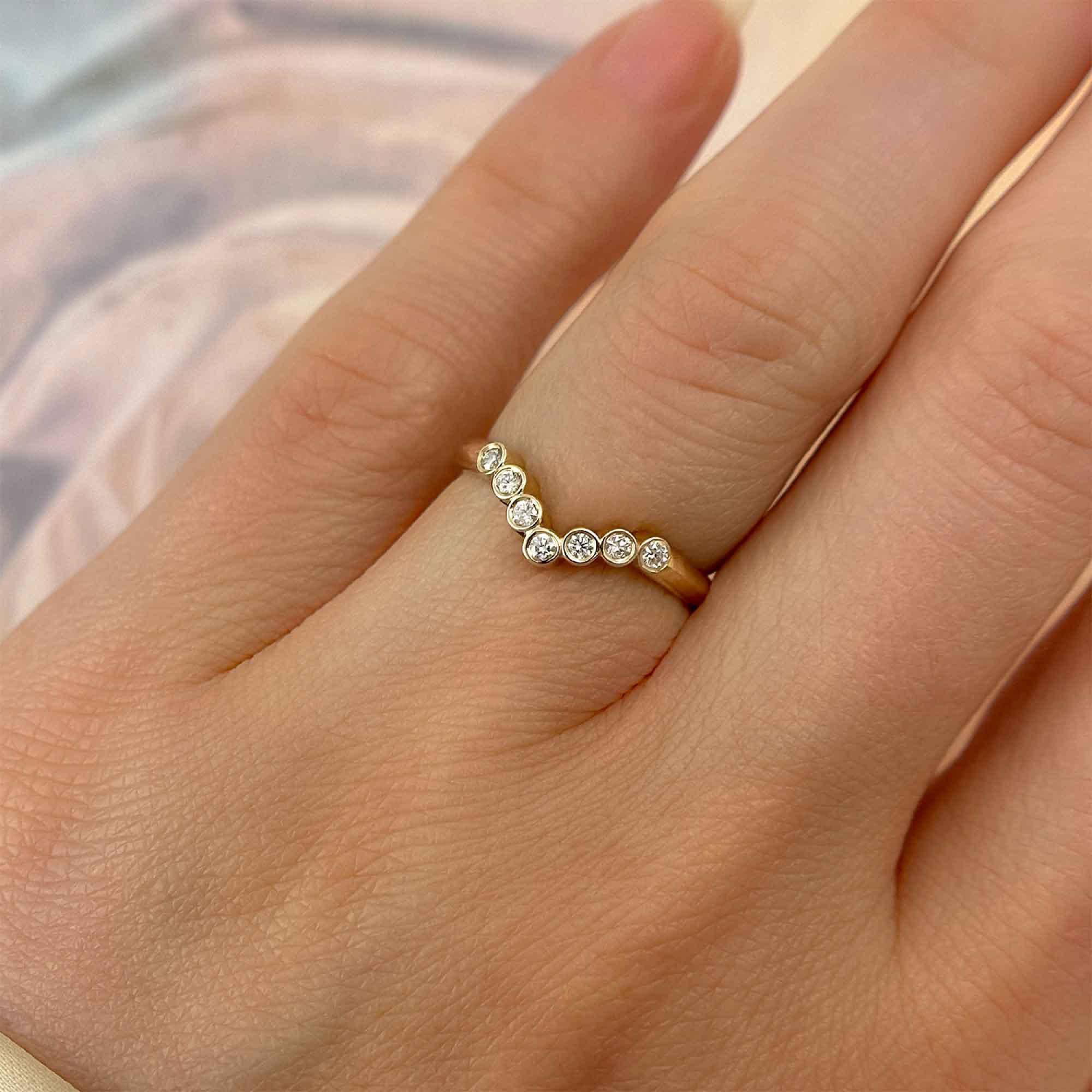 Diamond Bezels Curved Yellow Gold Band, on Ring Finger