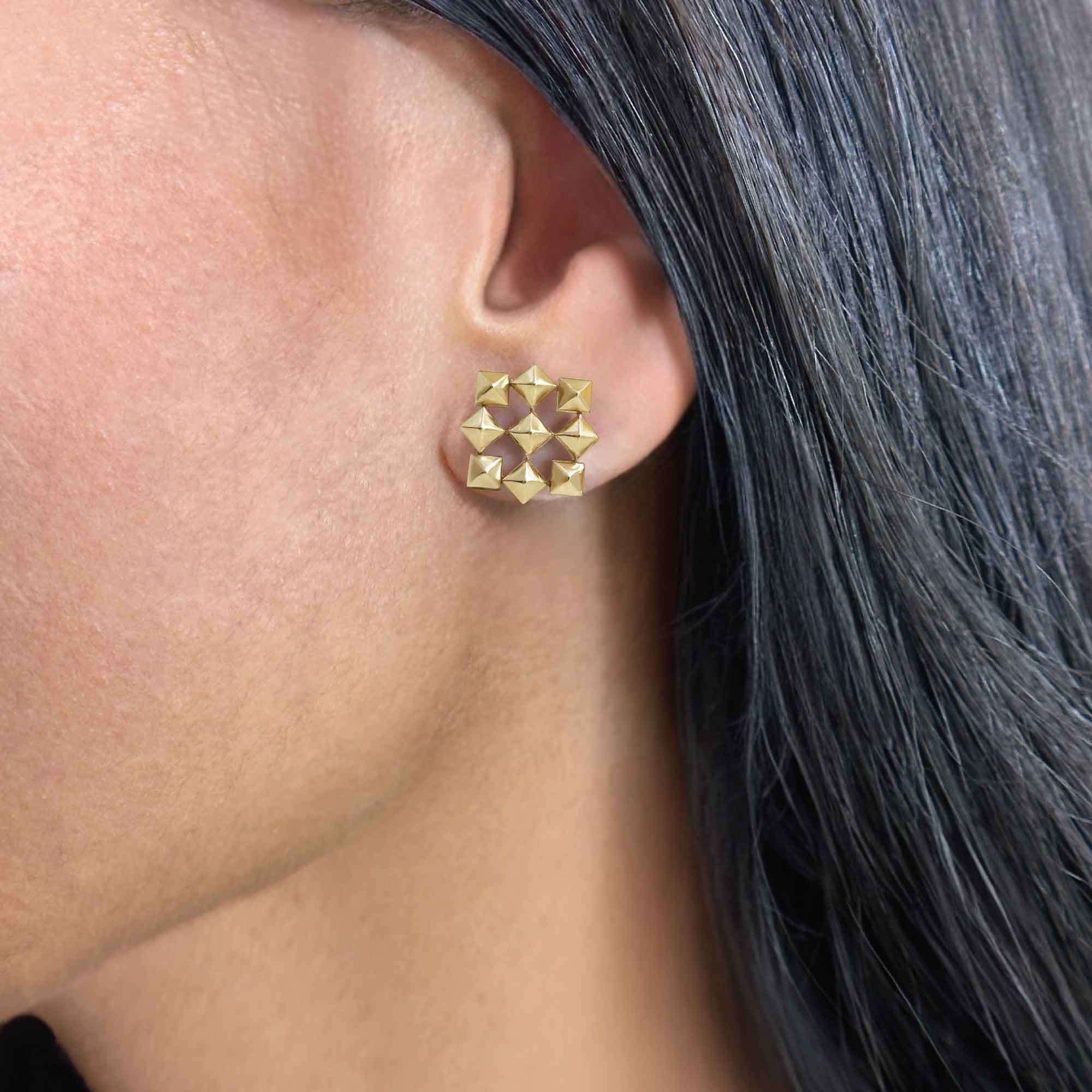 Gold Interlocking Pyramid Earrings, on ear