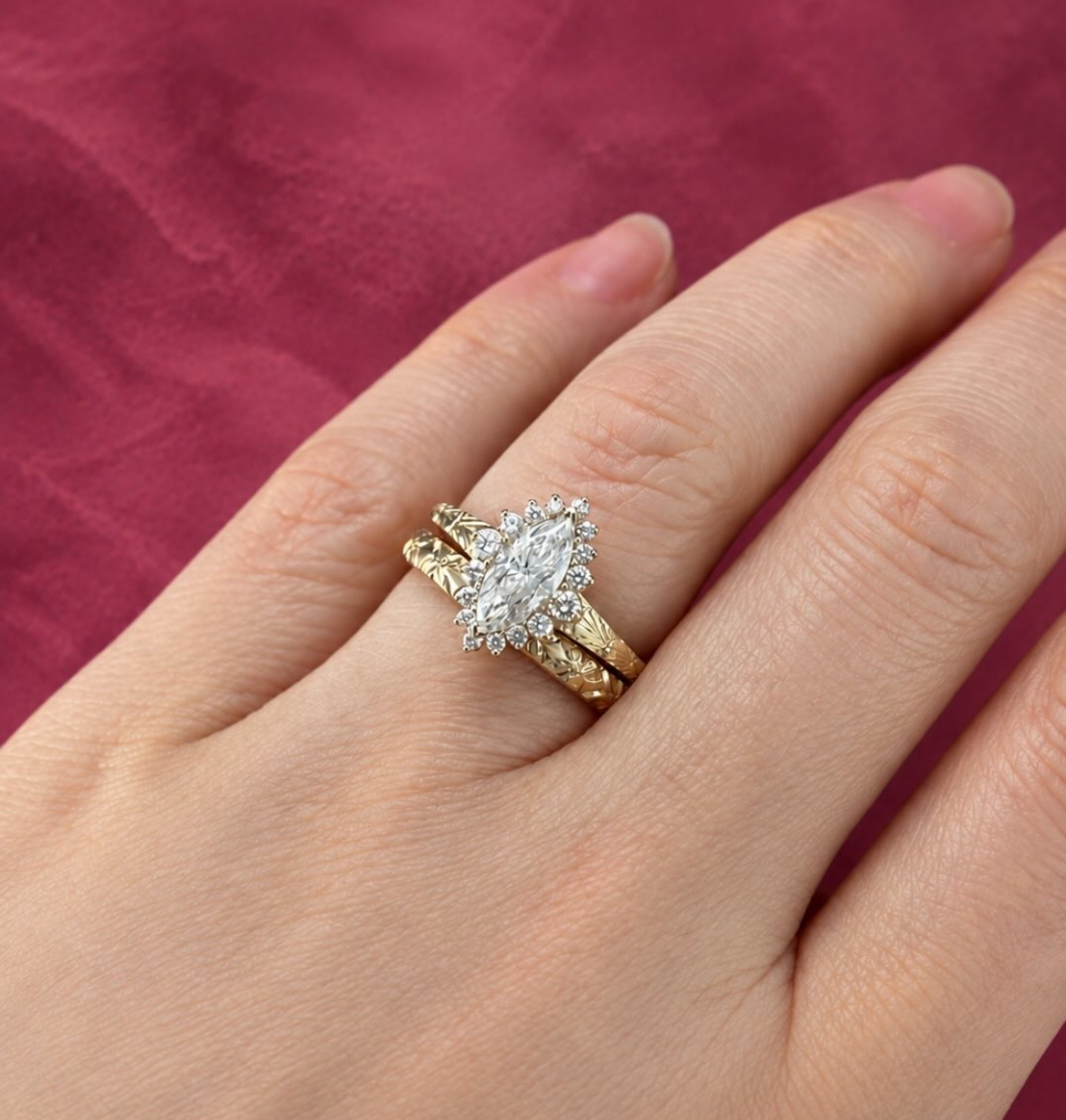 Marquise halo engagement ring with hand-engraved band